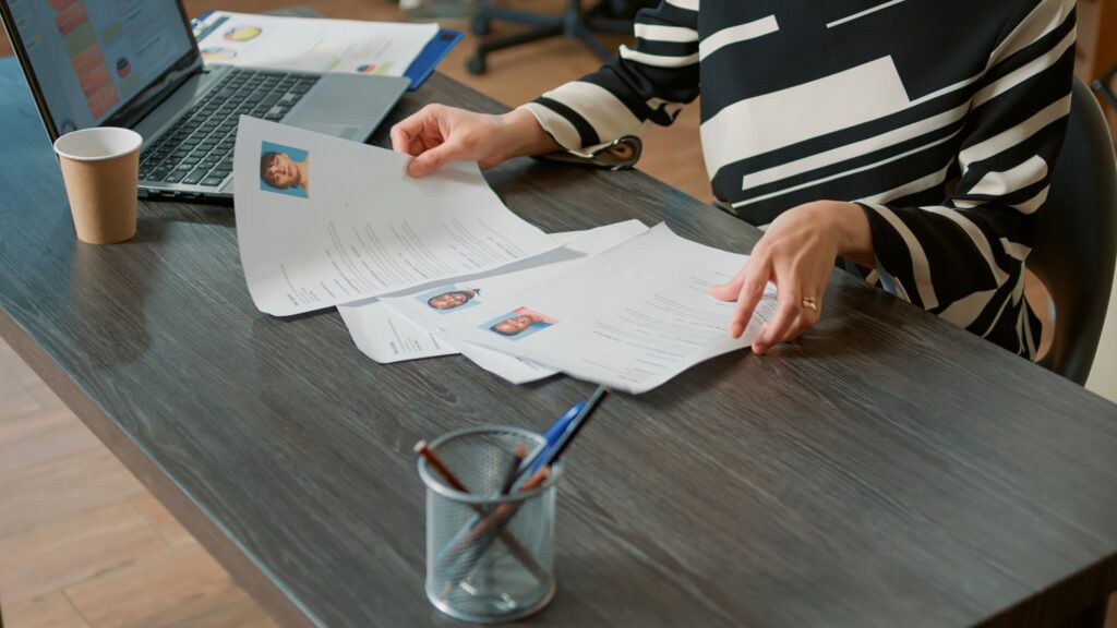 Recruiter comparing resumes